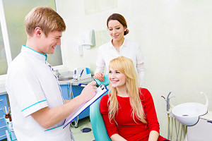 Female patient in dentist office, answering doctor  questions